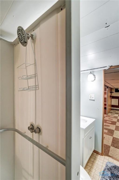 bathroom featuring a shower, vanity, and tile patterned floors