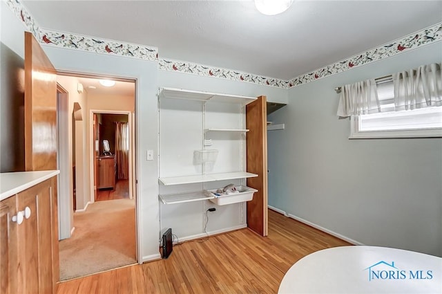 bathroom with baseboards and wood finished floors