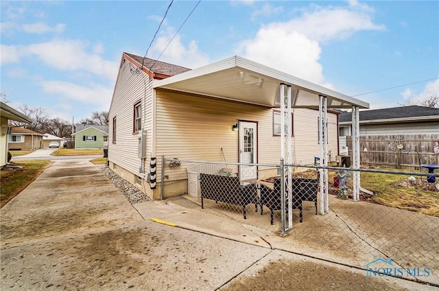 rear view of house featuring fence