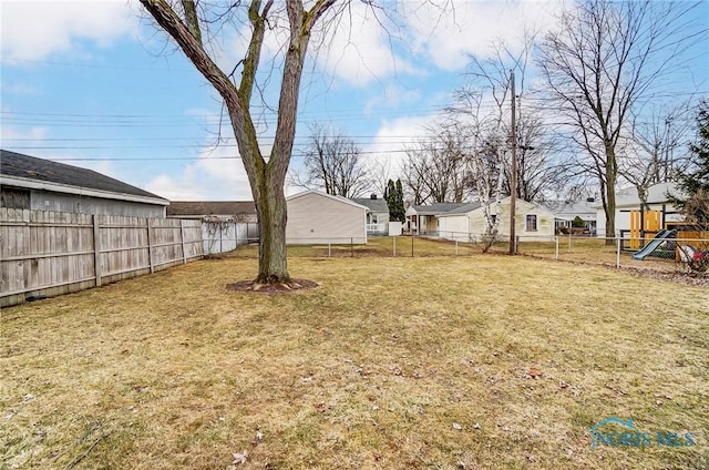 view of yard with a playground and a fenced backyard