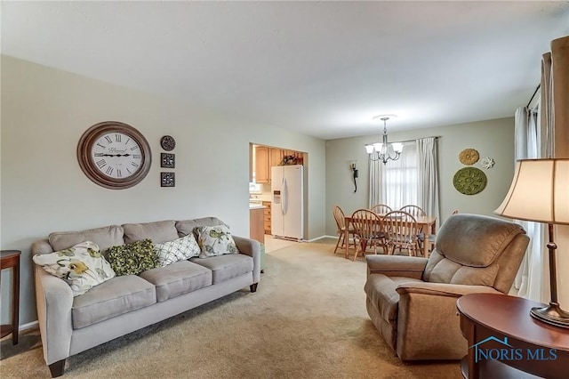 living room featuring light carpet and an inviting chandelier