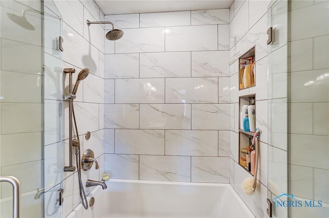 bathroom with shower / bath combination with glass door