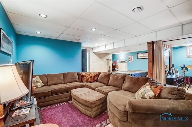 living area featuring visible vents, a paneled ceiling, and recessed lighting