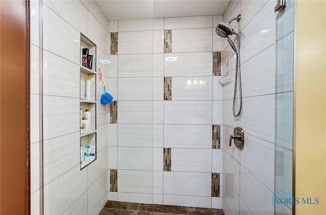 full bath with a tile shower