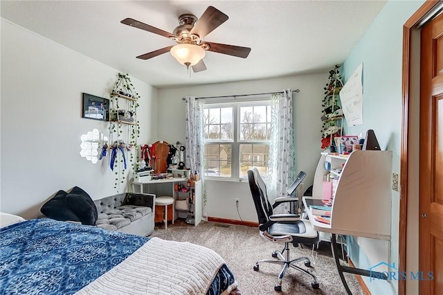 carpeted bedroom featuring a ceiling fan and baseboards