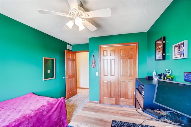 bedroom with a closet, a ceiling fan, and baseboards