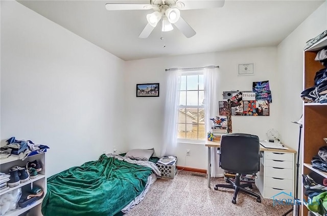 carpeted bedroom featuring a ceiling fan and baseboards