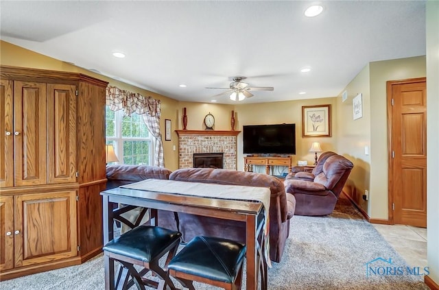 living area featuring a brick fireplace, ceiling fan, baseboards, and recessed lighting