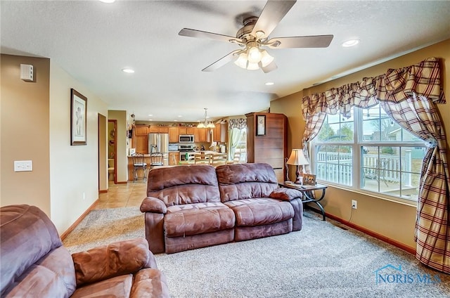 living room with light carpet, baseboards, a ceiling fan, and recessed lighting