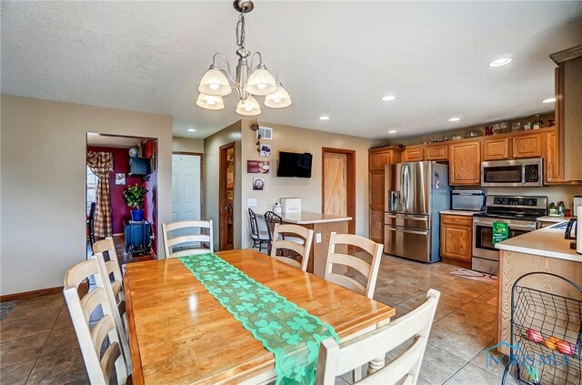 dining room with light tile patterned floors, baseboards, and recessed lighting