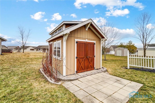 view of shed featuring fence