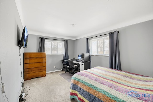 bedroom with light carpet and baseboards