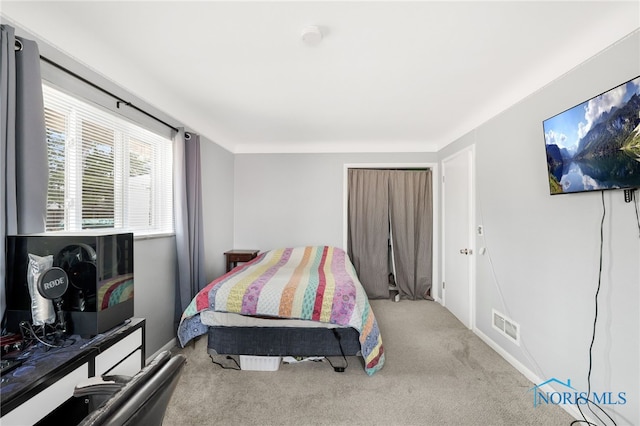 carpeted bedroom featuring visible vents