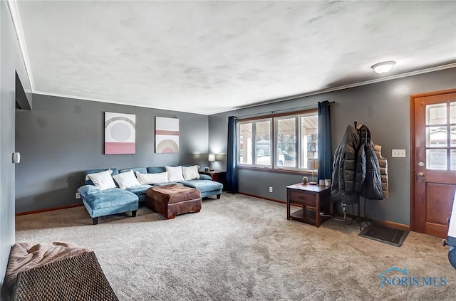 carpeted living room with ornamental molding and baseboards