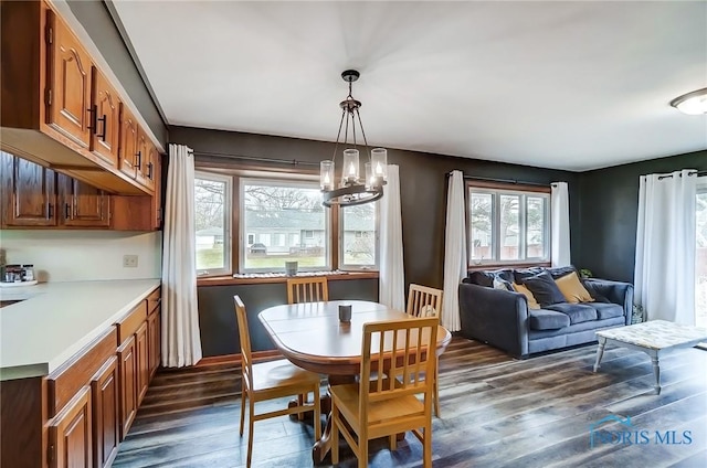 dining room featuring dark wood-style floors and a notable chandelier