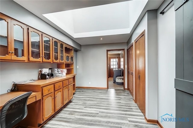 bar with light wood-type flooring and baseboards