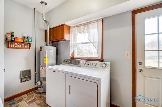 washroom with heating unit, plenty of natural light, water heater, and separate washer and dryer