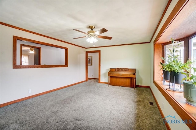 unfurnished room featuring carpet floors, visible vents, crown molding, and baseboards