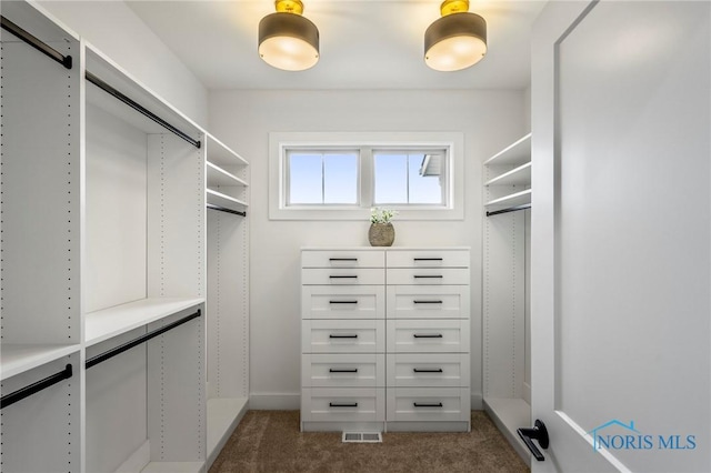 spacious closet featuring dark carpet