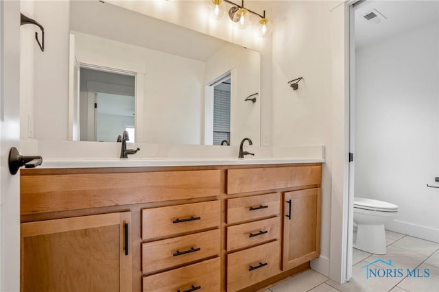 full bathroom with double vanity, visible vents, toilet, a sink, and tile patterned flooring