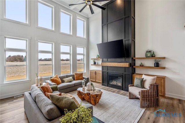 living area with light wood-type flooring and a healthy amount of sunlight