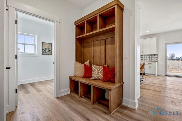 mudroom with light wood-type flooring, baseboards, and recessed lighting