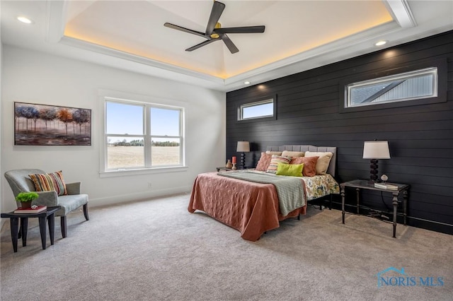 carpeted bedroom with a ceiling fan, a tray ceiling, baseboards, and recessed lighting