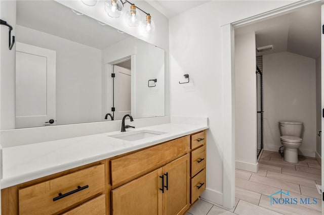 full bath with toilet, a stall shower, vanity, and baseboards