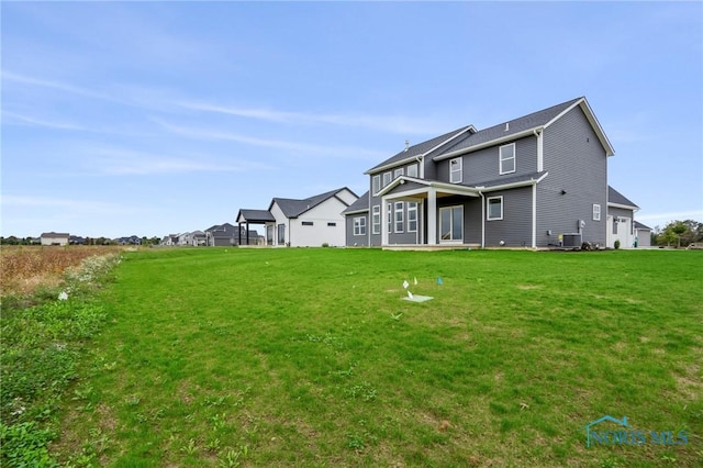 back of property with a lawn and cooling unit