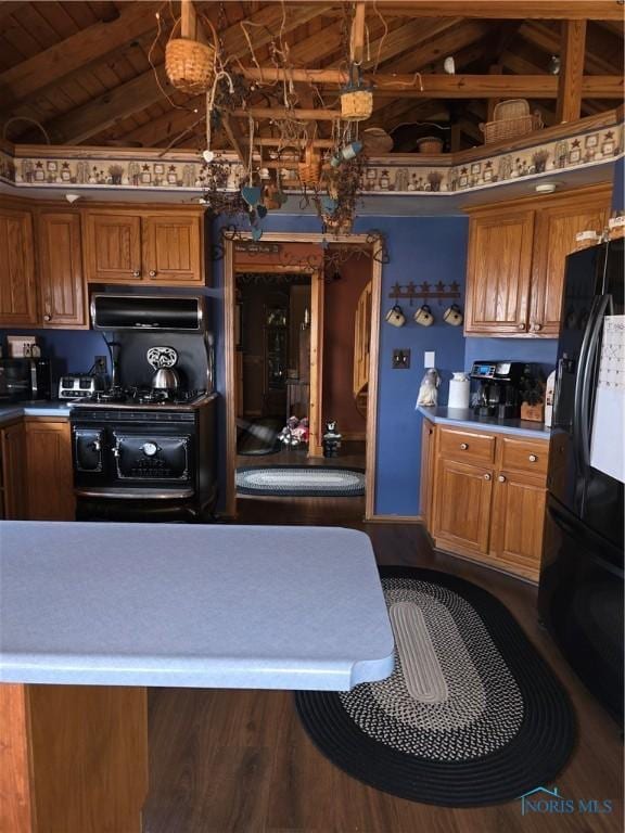 kitchen with lofted ceiling with beams, brown cabinets, and black fridge with ice dispenser