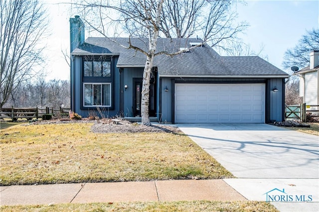 view of front of house with a front yard, fence, an attached garage, a chimney, and concrete driveway