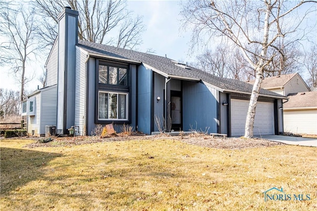 view of front facade featuring a front yard, roof with shingles, a chimney, driveway, and an attached garage