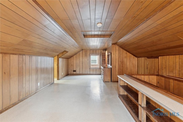 bonus room with lofted ceiling, wooden ceiling, and wooden walls