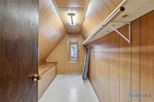 interior space with lofted ceiling, wooden ceiling, and wooden walls