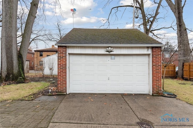 detached garage featuring fence