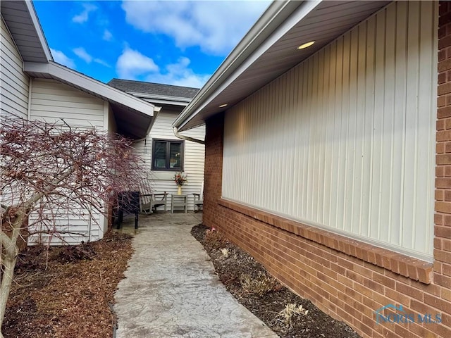 view of side of home featuring brick siding