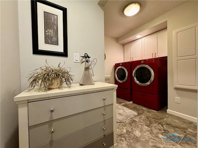 laundry area featuring washer and clothes dryer and cabinet space