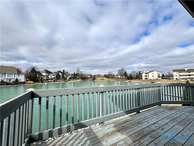 wooden terrace featuring a water view