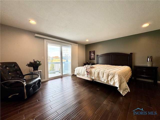 bedroom with access to exterior, recessed lighting, dark wood-type flooring, and a textured ceiling