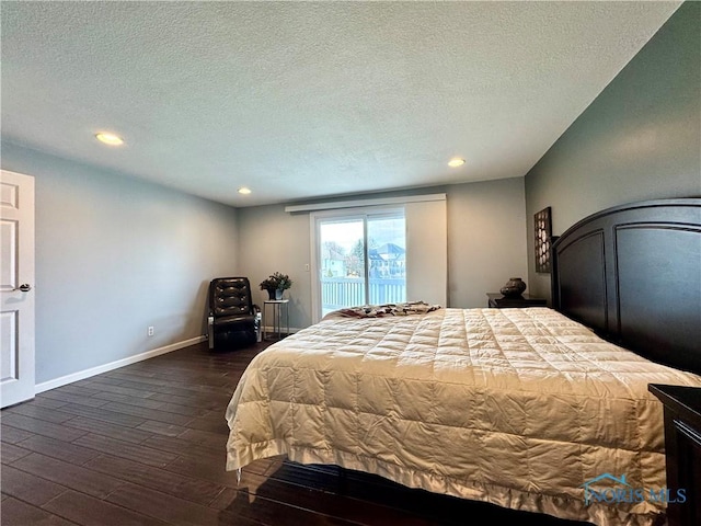 bedroom featuring a textured ceiling, recessed lighting, dark wood-type flooring, baseboards, and access to outside