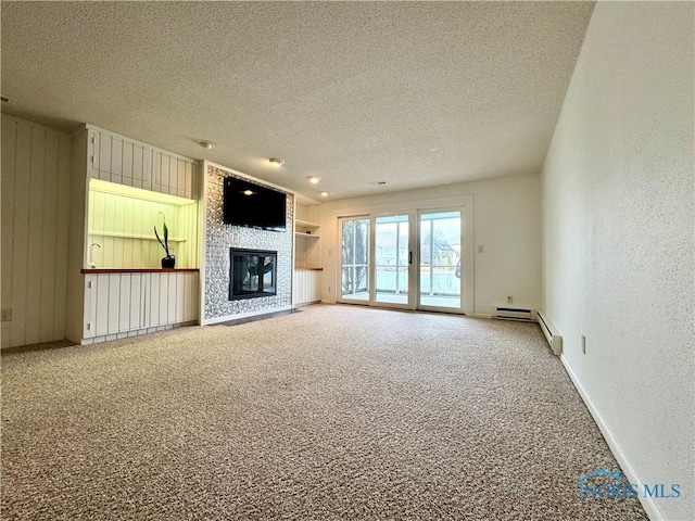 unfurnished living room featuring a textured ceiling, a textured wall, a baseboard radiator, a fireplace, and carpet flooring