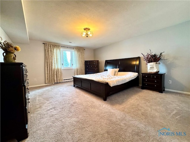 bedroom featuring a baseboard heating unit, light colored carpet, a textured ceiling, and baseboards