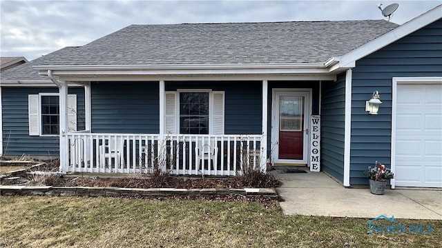 doorway to property featuring a garage, covered porch, and roof with shingles