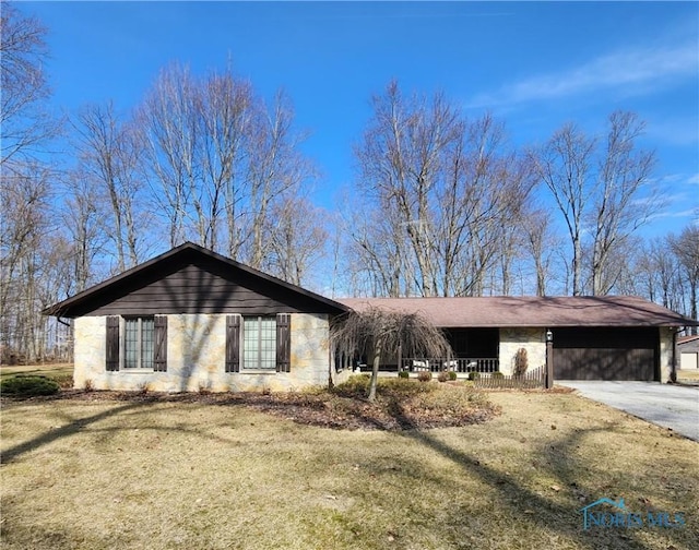 ranch-style house with driveway, a carport, and a front lawn