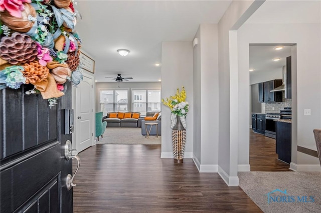 foyer entrance with a ceiling fan, dark wood-style flooring, and baseboards