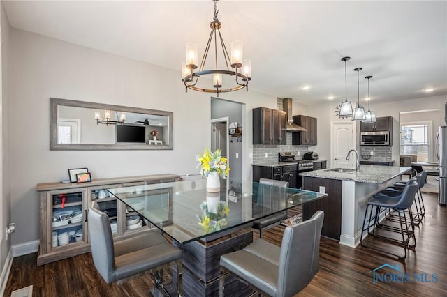 dining room with baseboards, visible vents, a chandelier, and dark wood-type flooring