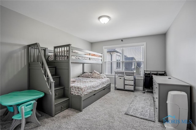 bedroom with light carpet and baseboards