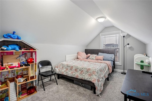 bedroom with vaulted ceiling, carpet flooring, and baseboards