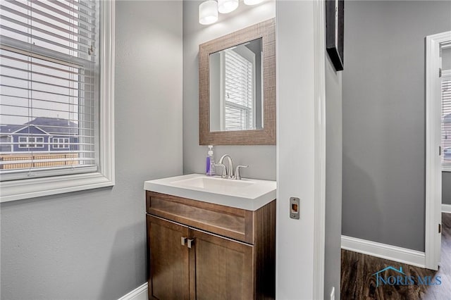 bathroom with plenty of natural light, vanity, and baseboards