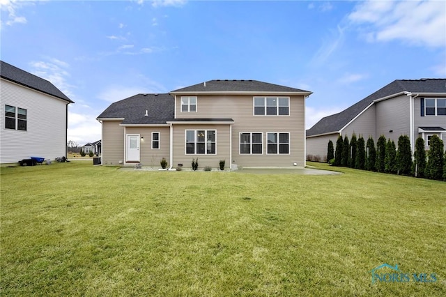 rear view of house with a lawn and a patio area